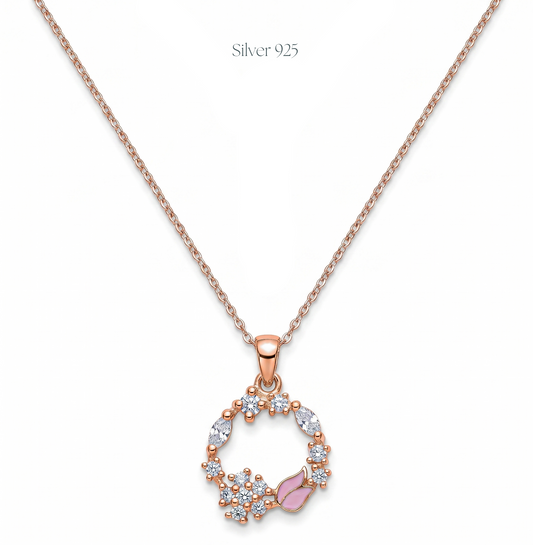 Rose gold necklace with a circular pendant featuring crystals and a pink gemstone on a white background.